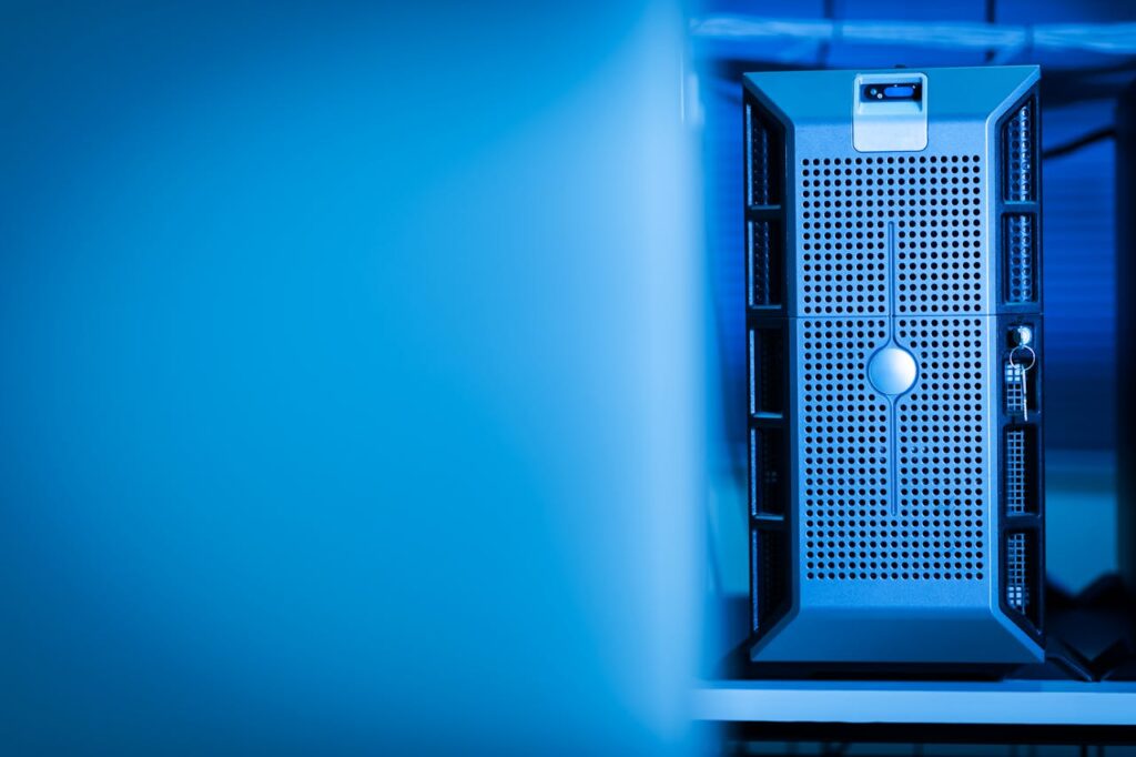 pexels-photo-17489163 Close-up of a modern server unit in a blue-lit data center environment.
